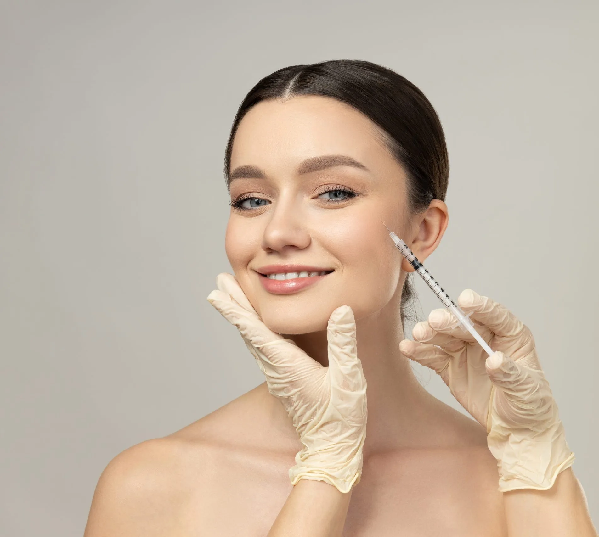 Woman receiving a cosmetic injection in her cheek