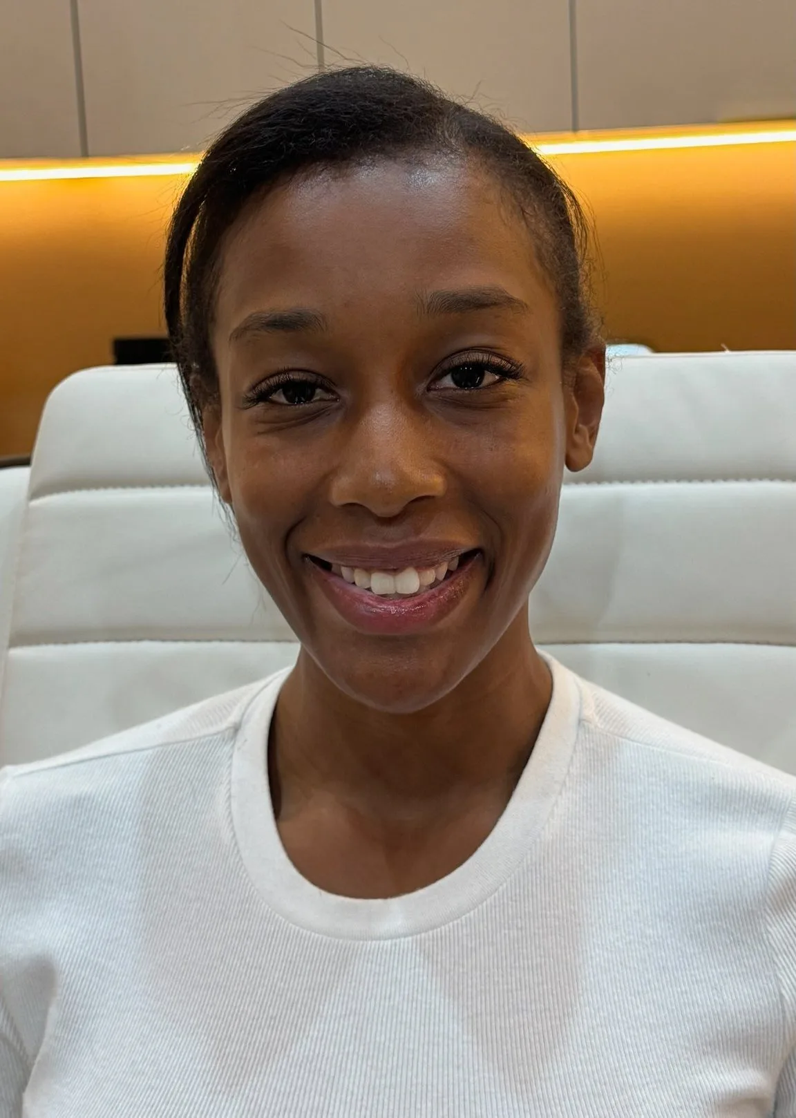 Smiling client in a treatment chair at La Réserve med spa, New York