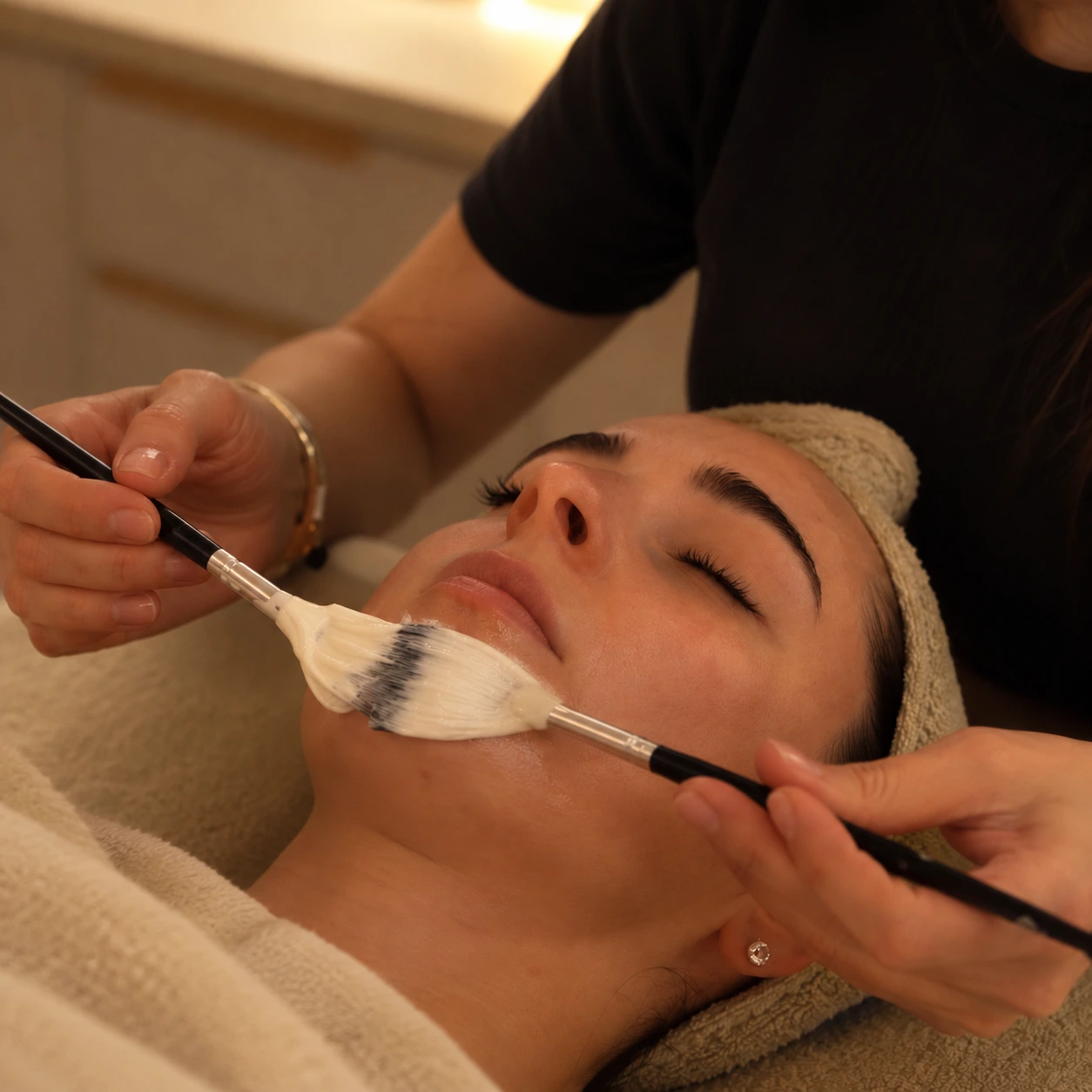 Woman receiving a warm spa facial mask treatment