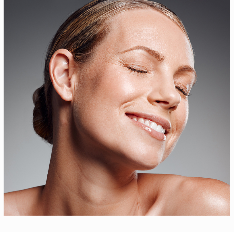 Woman's face in profile showing defined cheekbones and jawline against neutral background