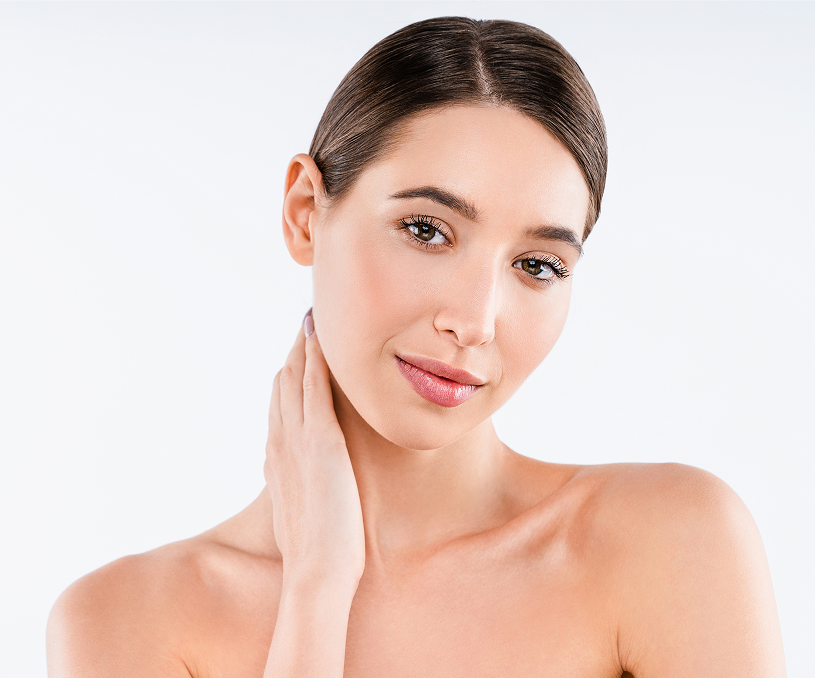 Woman touching her neck and jawline, demonstrating skin firmness and tone