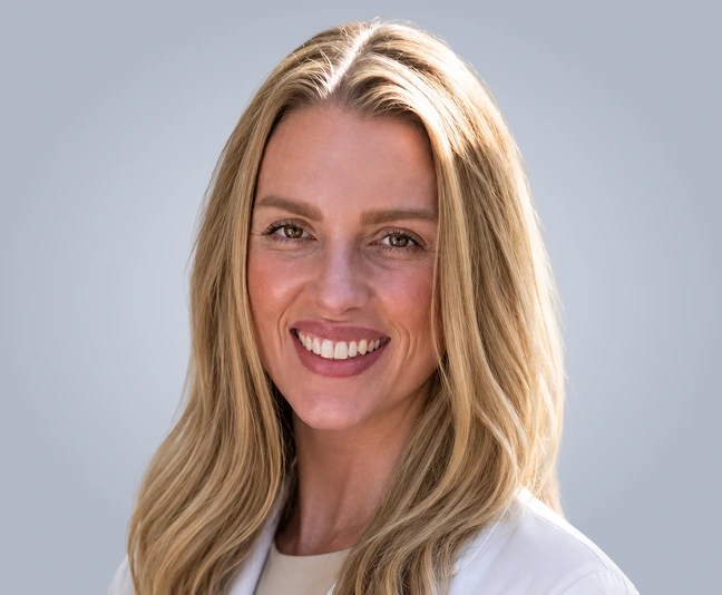 Woman with blonde hair smiling at camera