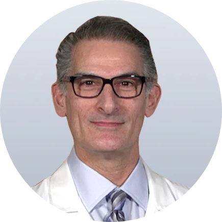 Male podiatrist in white coat and glasses, headshot