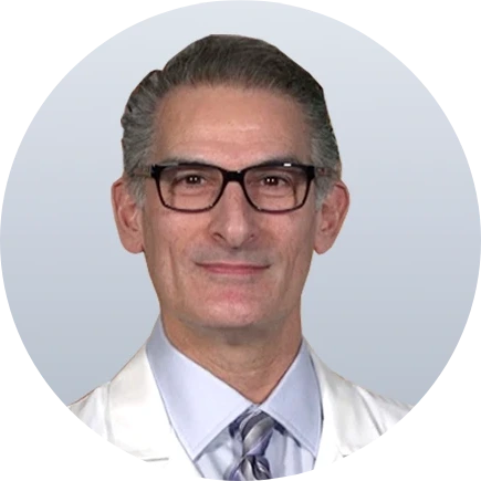 Male podiatrist in white coat and glasses, headshot