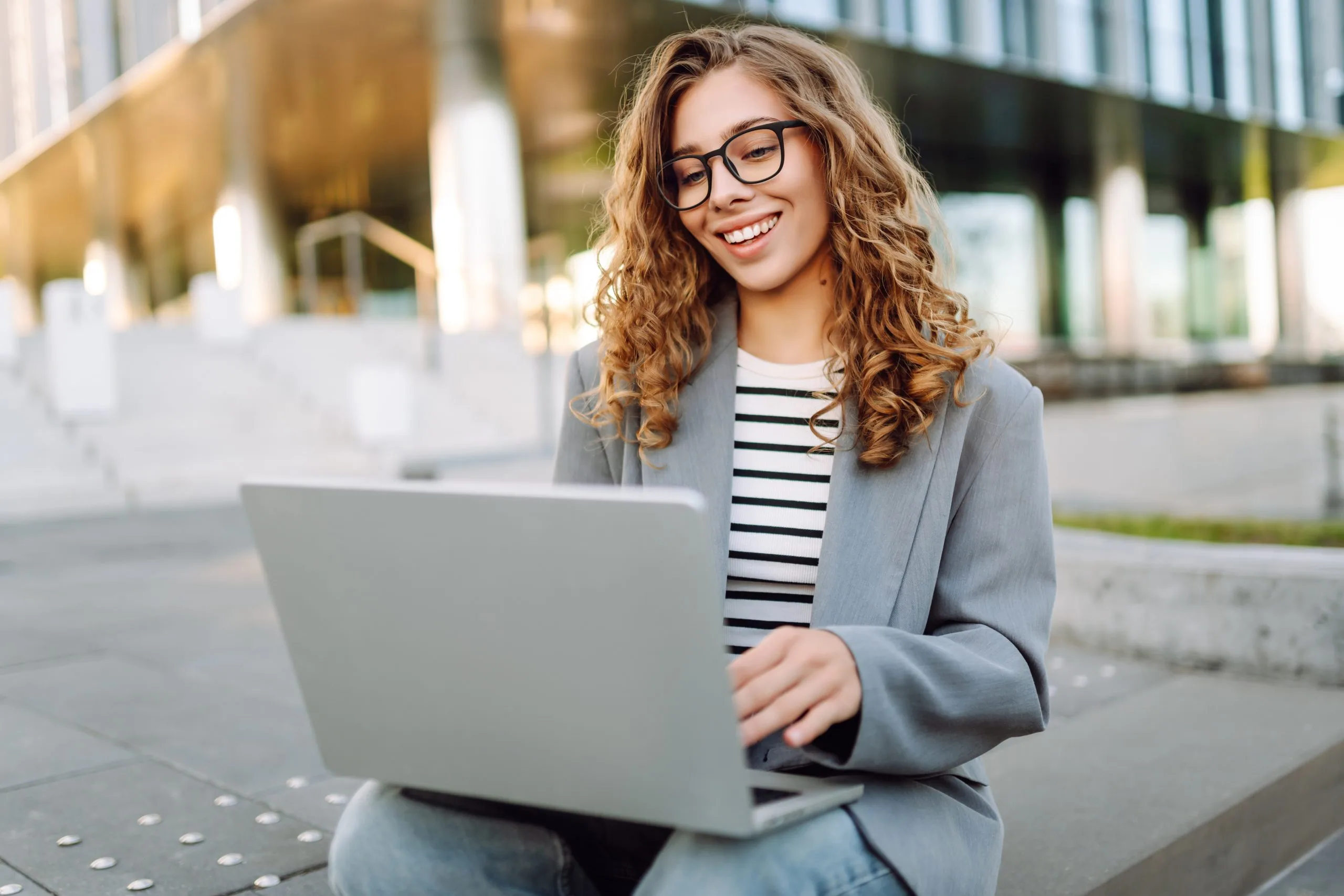 Woman on her laptop reviewing out-of-network insurance benefits for testing