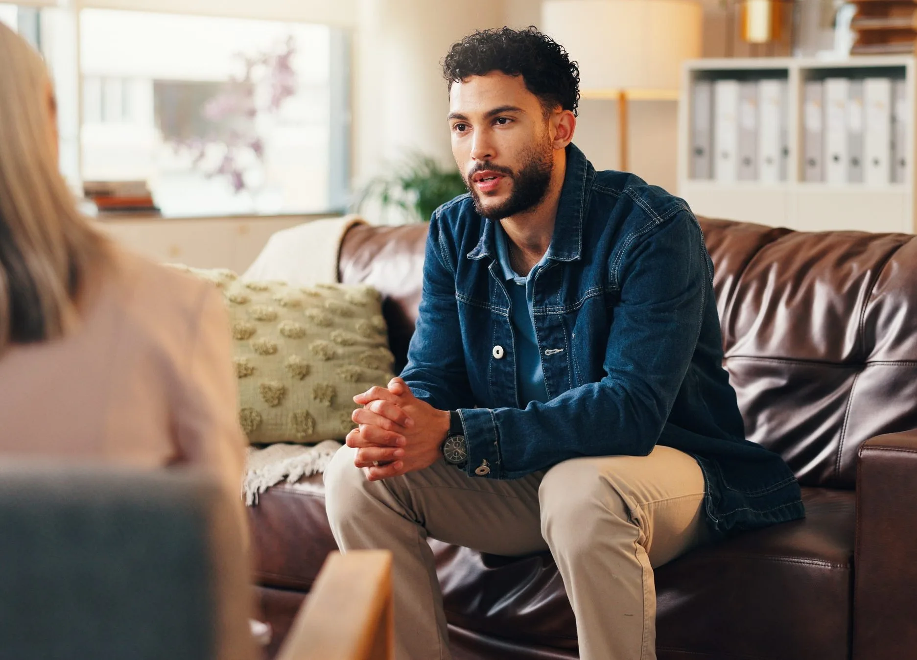 Young man talking through his psychological evaluation results with a clinician