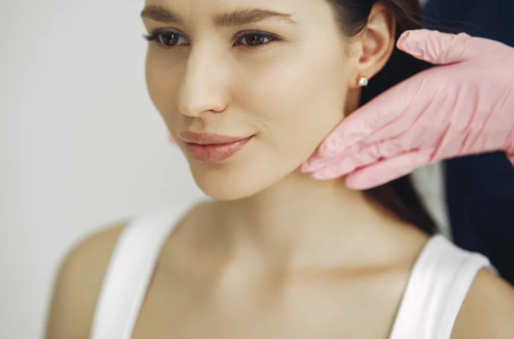 Provider examining a patient chin and jawline