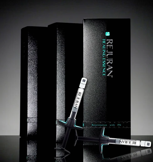 Rejuran Healing Essence product boxes and syringes displayed against dark background