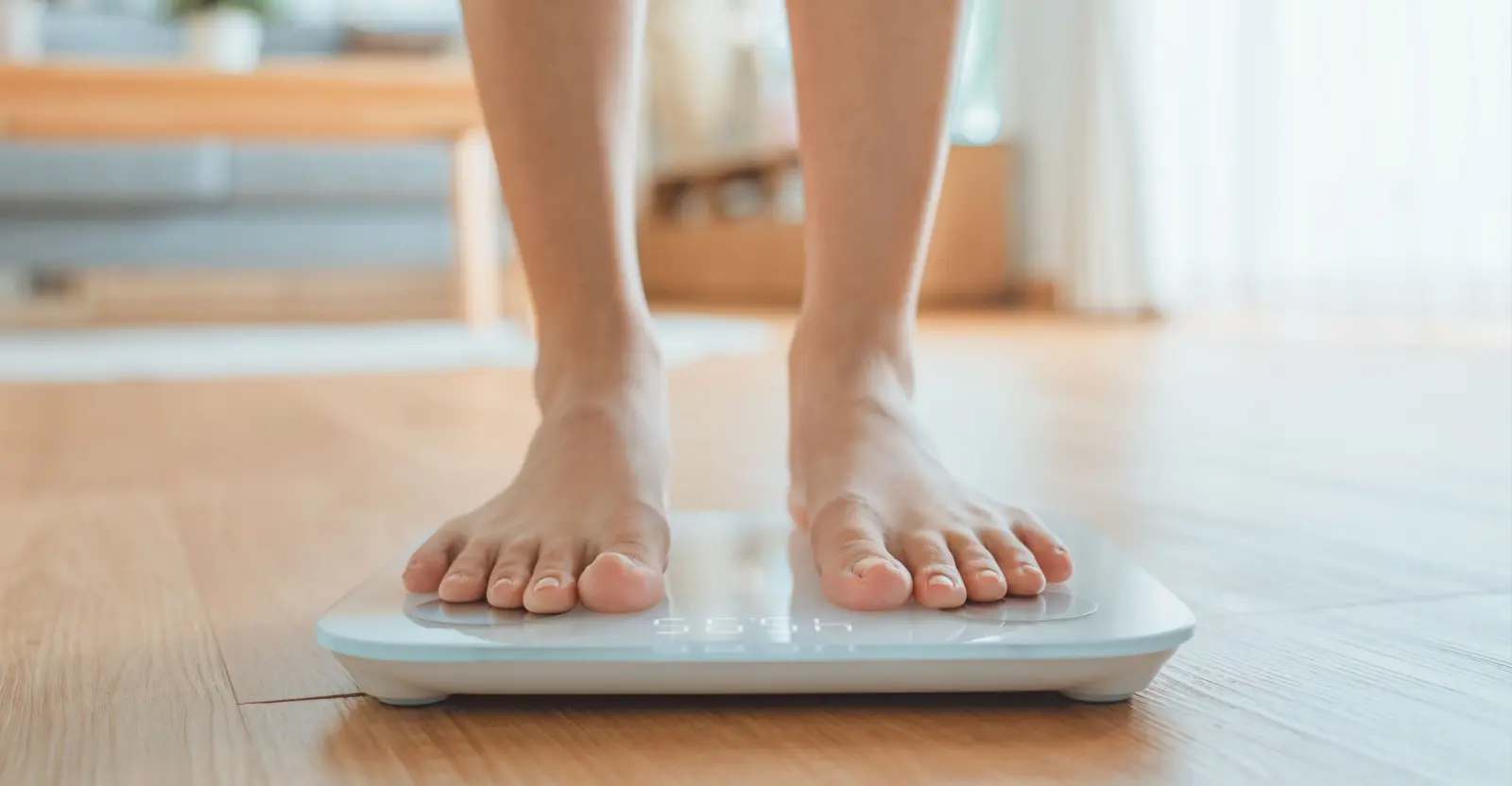 Person standing on a bathroom scale to weigh themselves