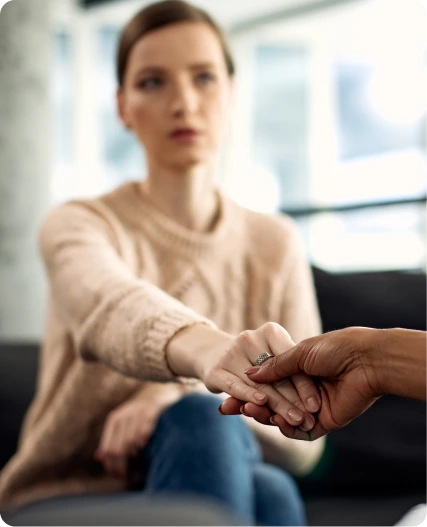 Two people holding hands during an Intensive Outpatient Program session
