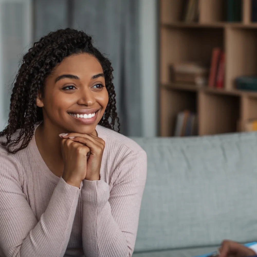 Woman smiling while talking with a clinician