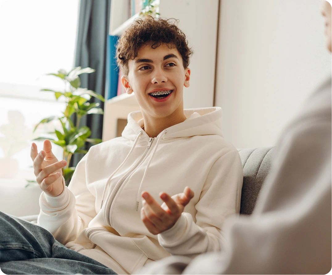 Adolescent in conversation during an intensive outpatient program session at Neowellnez