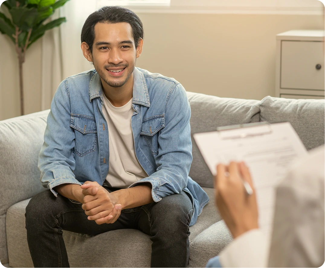 Man smiling during individual therapy session with a therapist in a calm office setting