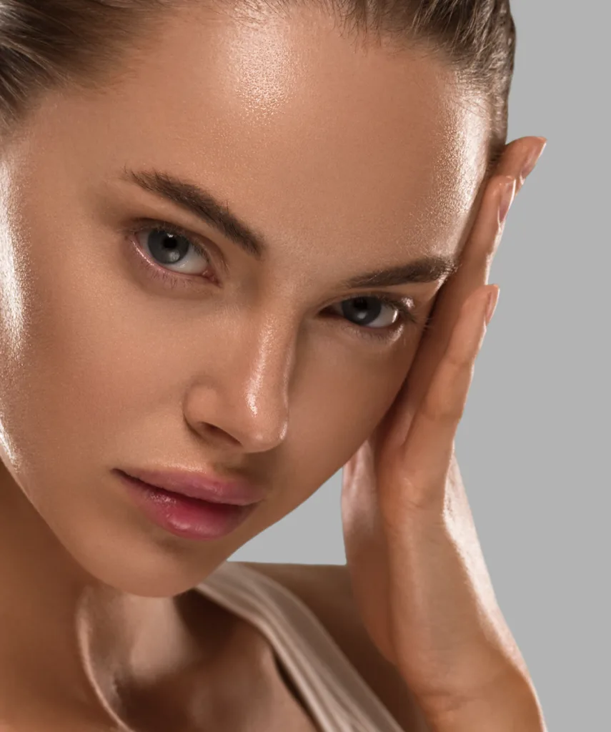 Woman's face in three-quarter view touching her cheek