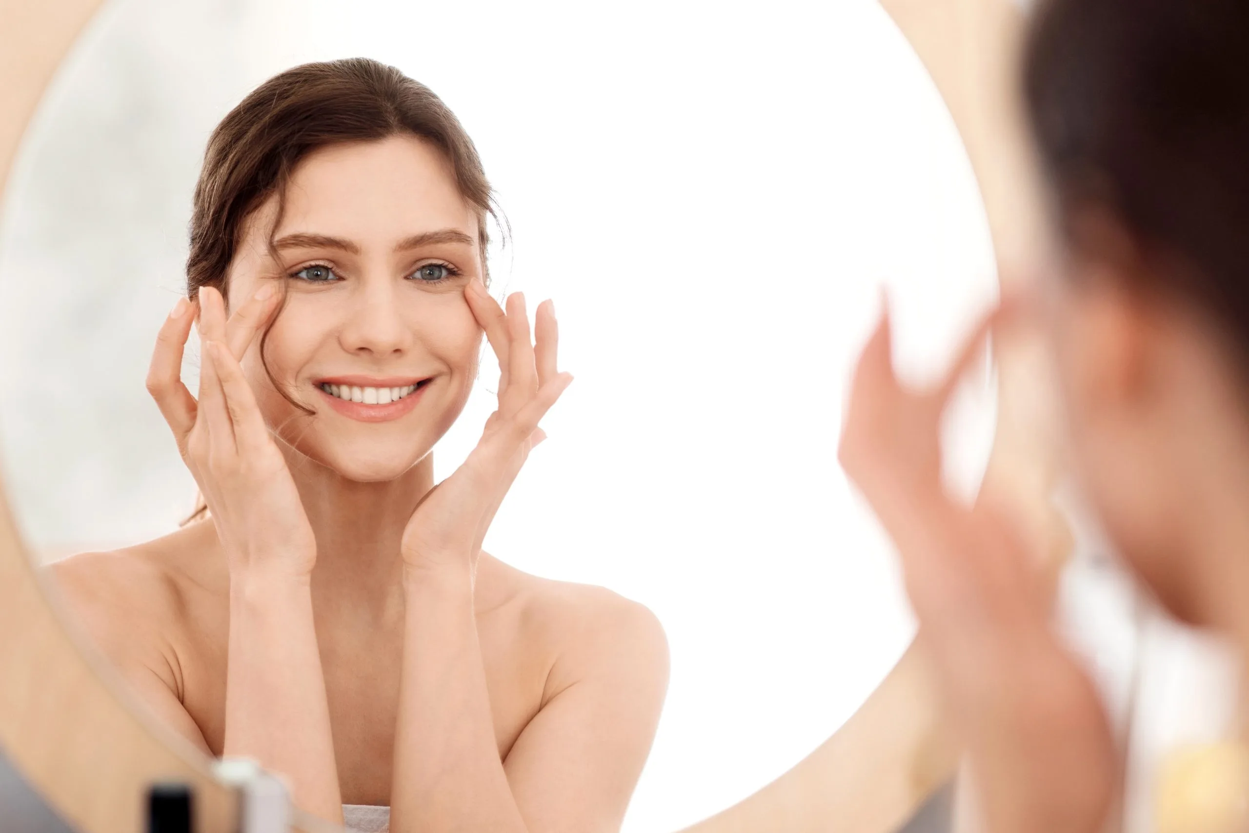 Woman examining her lifted brow and forehead in a mirror