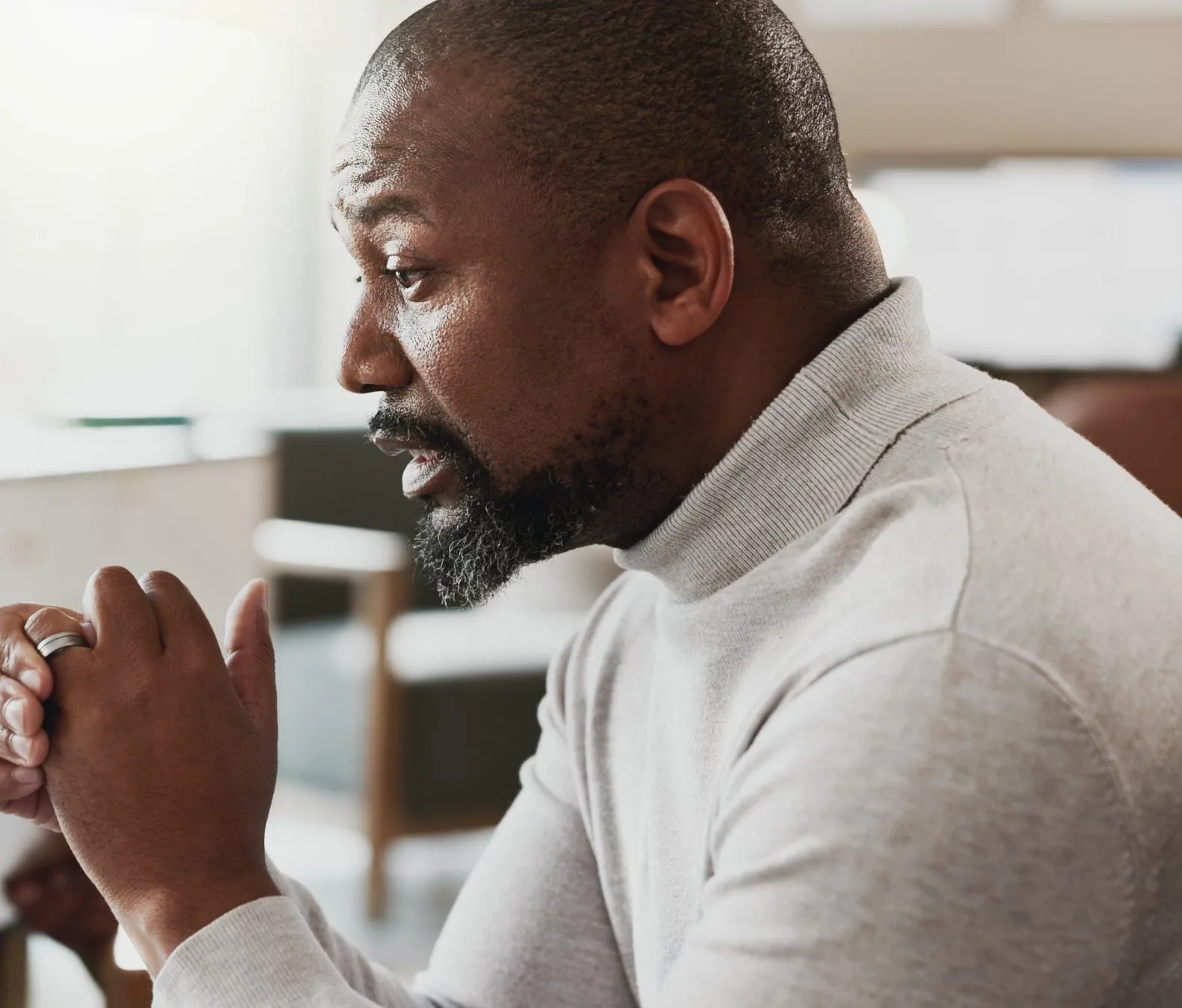 Man gesturing while speaking in therapeutic or counseling conversation