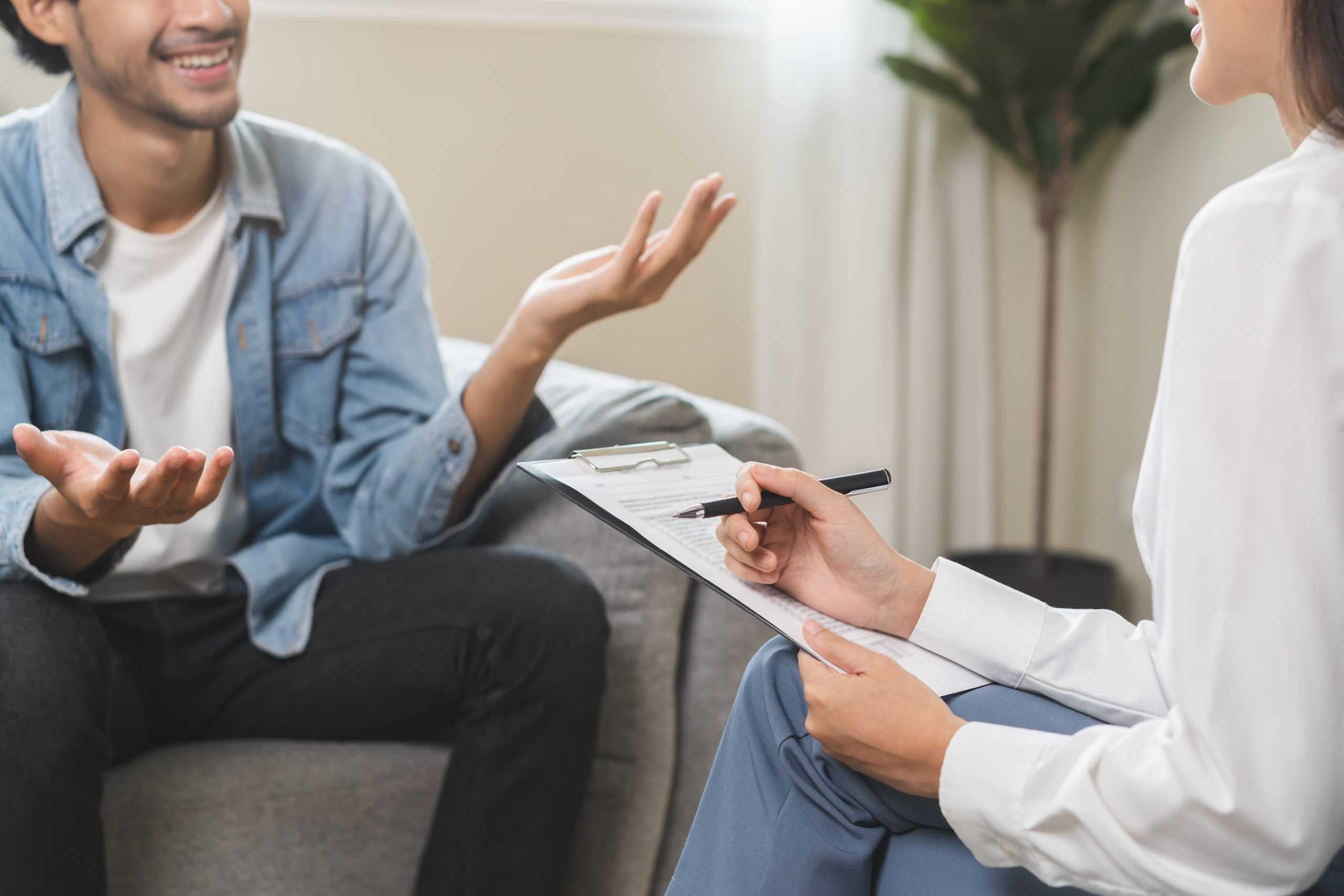Patient discussing treatment plan with healthcare provider holding clipboard