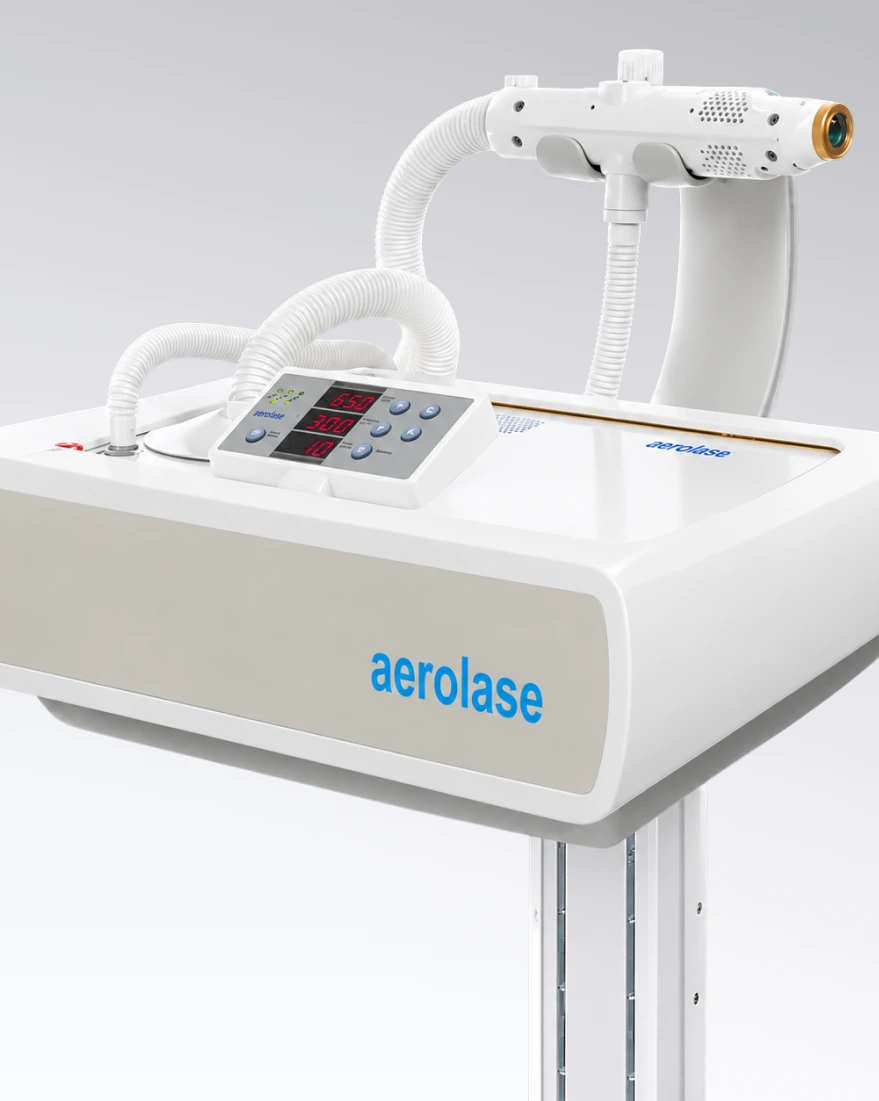 Aerolase laser device on treatment table with handpiece, control panel, and tubing