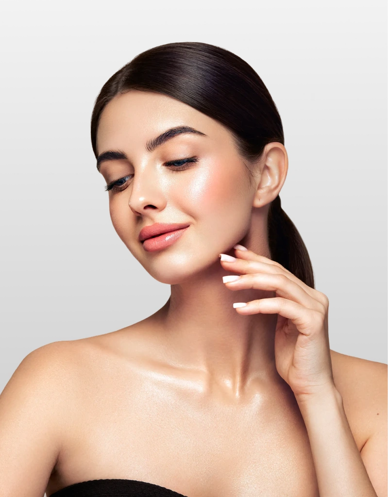 Woman with glowing skin touching her face and neck with eyes closed