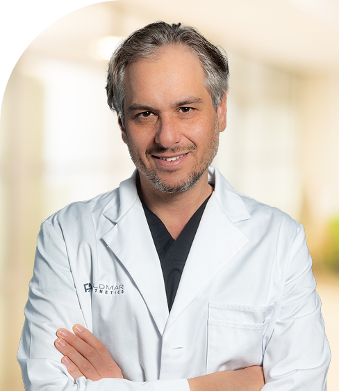 Dr. David Feldmar, plastic surgeon at Plastic Rejuvenation Medical, in white coat with arms crossed
