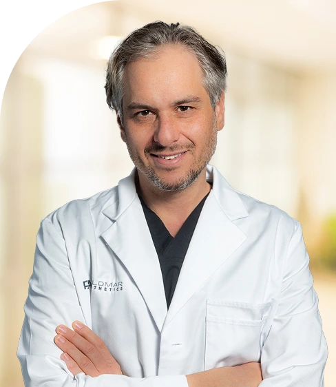 Dr. David Feldmar, plastic surgeon at Plastic Rejuvenation Medical, in white coat with arms crossed