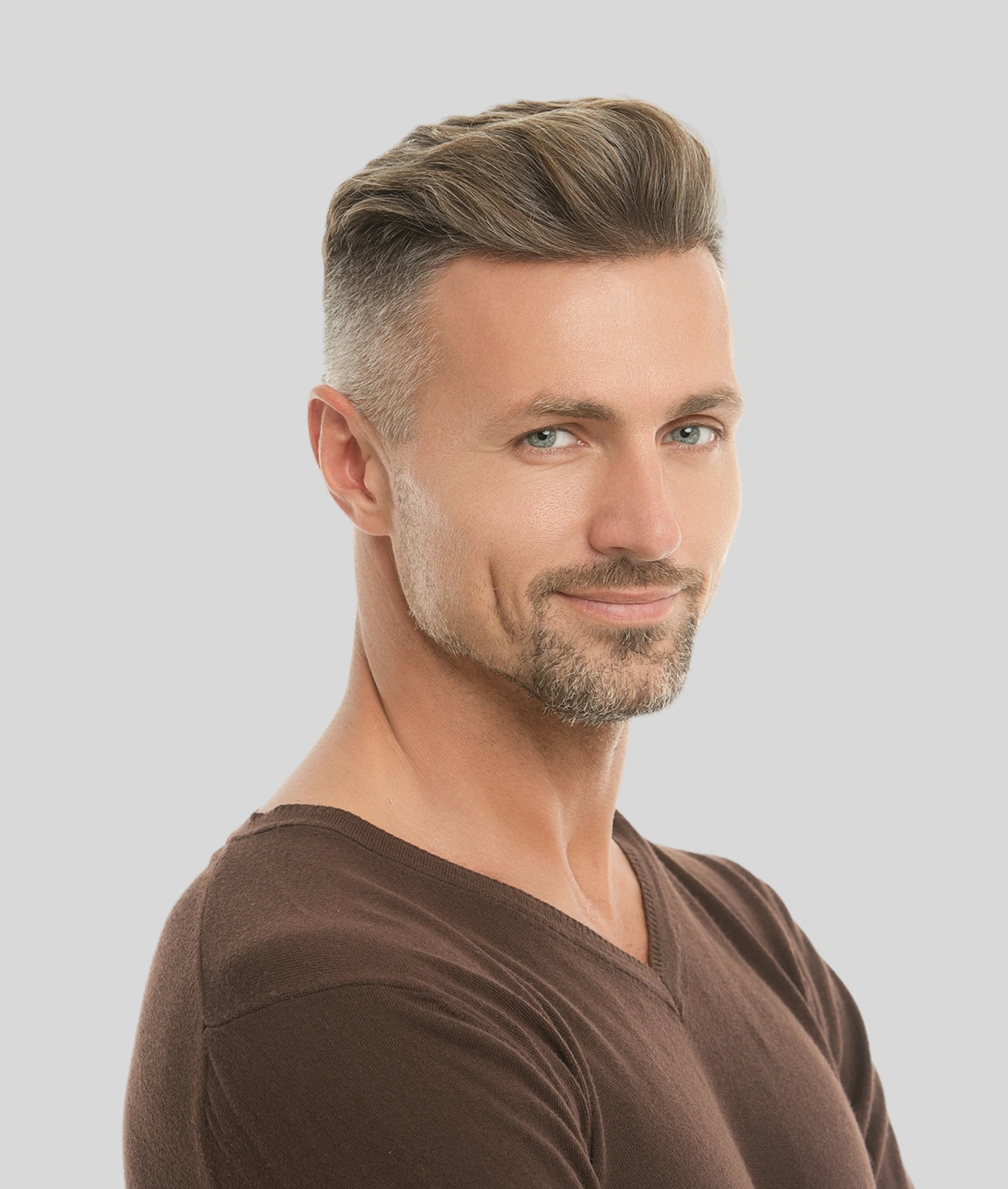 Male model in profile wearing brown shirt against neutral background