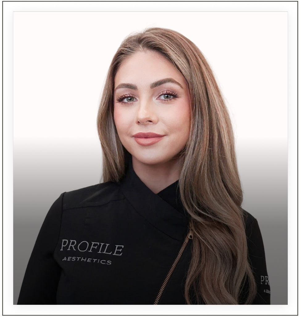 Team member wearing Profile Aesthetics branded black jacket, professional headshot