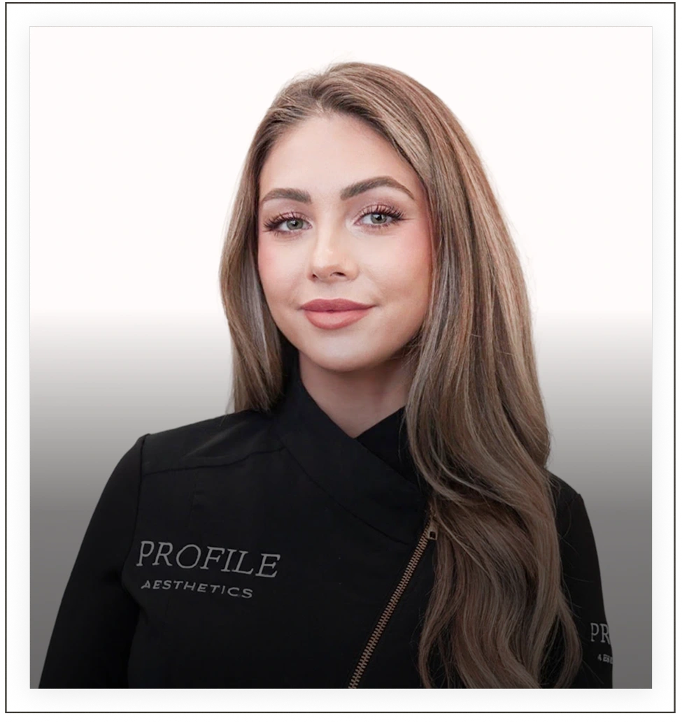 Team member wearing Profile Aesthetics branded black jacket, professional headshot