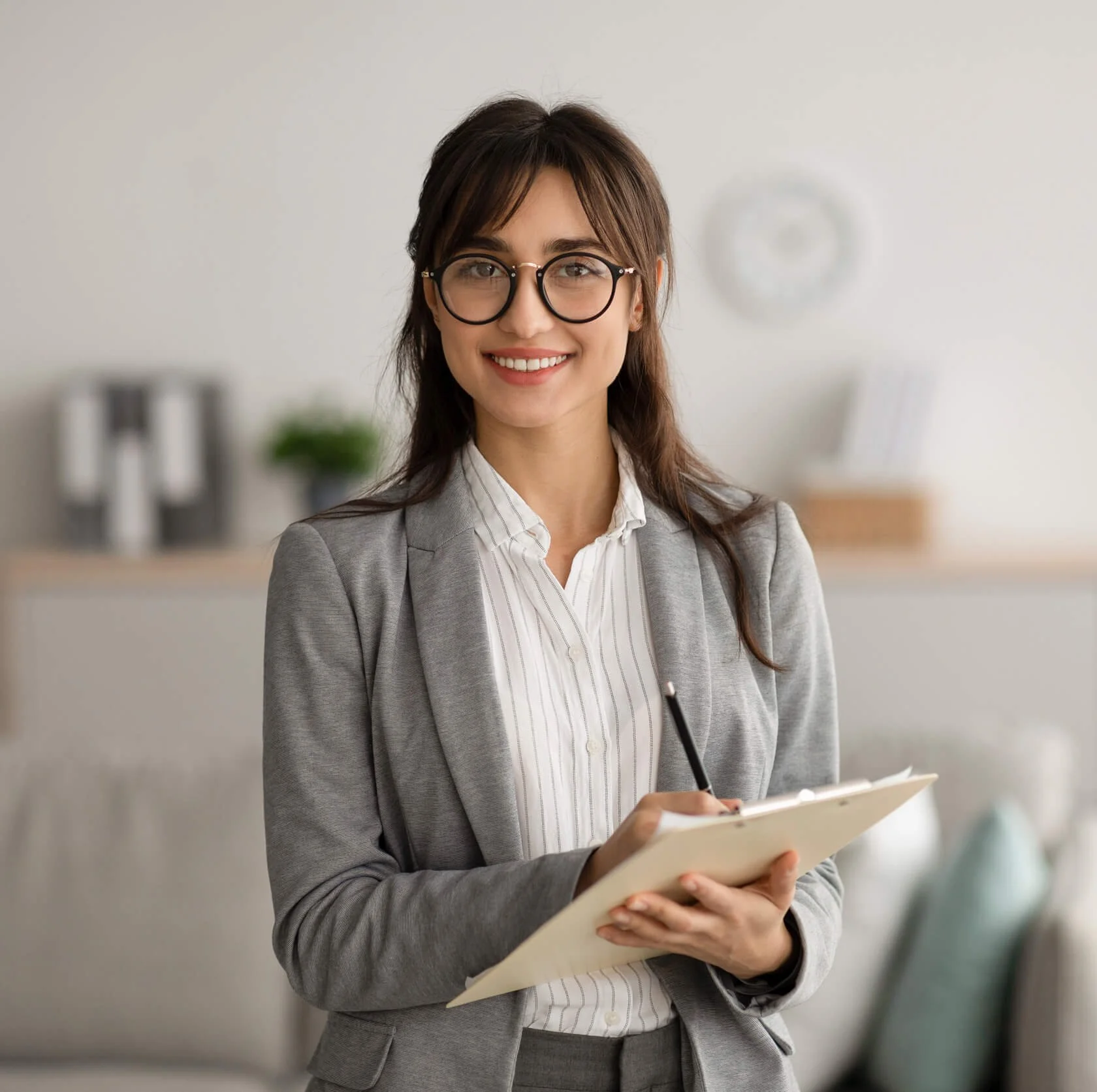 Smiling professional woman in a blazer in an office