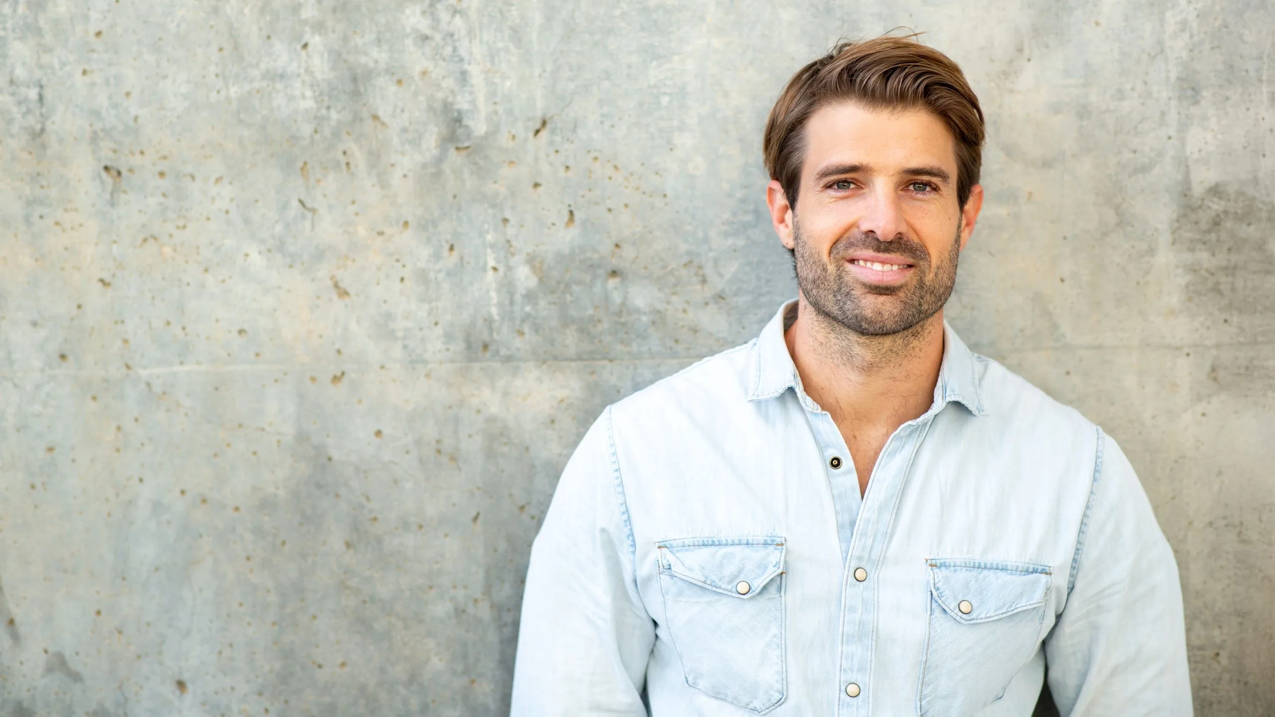 Smiling man in a denim shirt