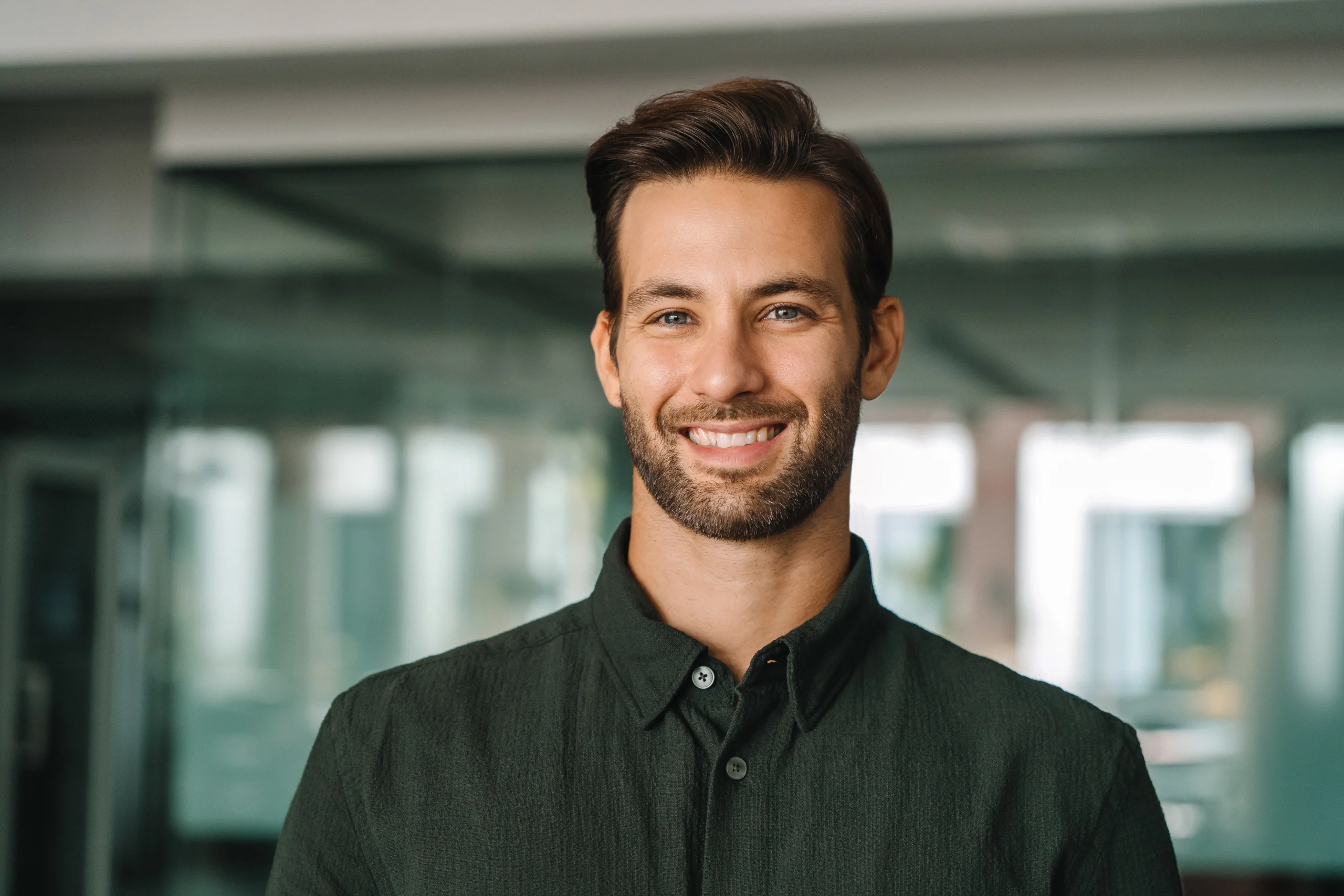 Smiling young man in a modern office