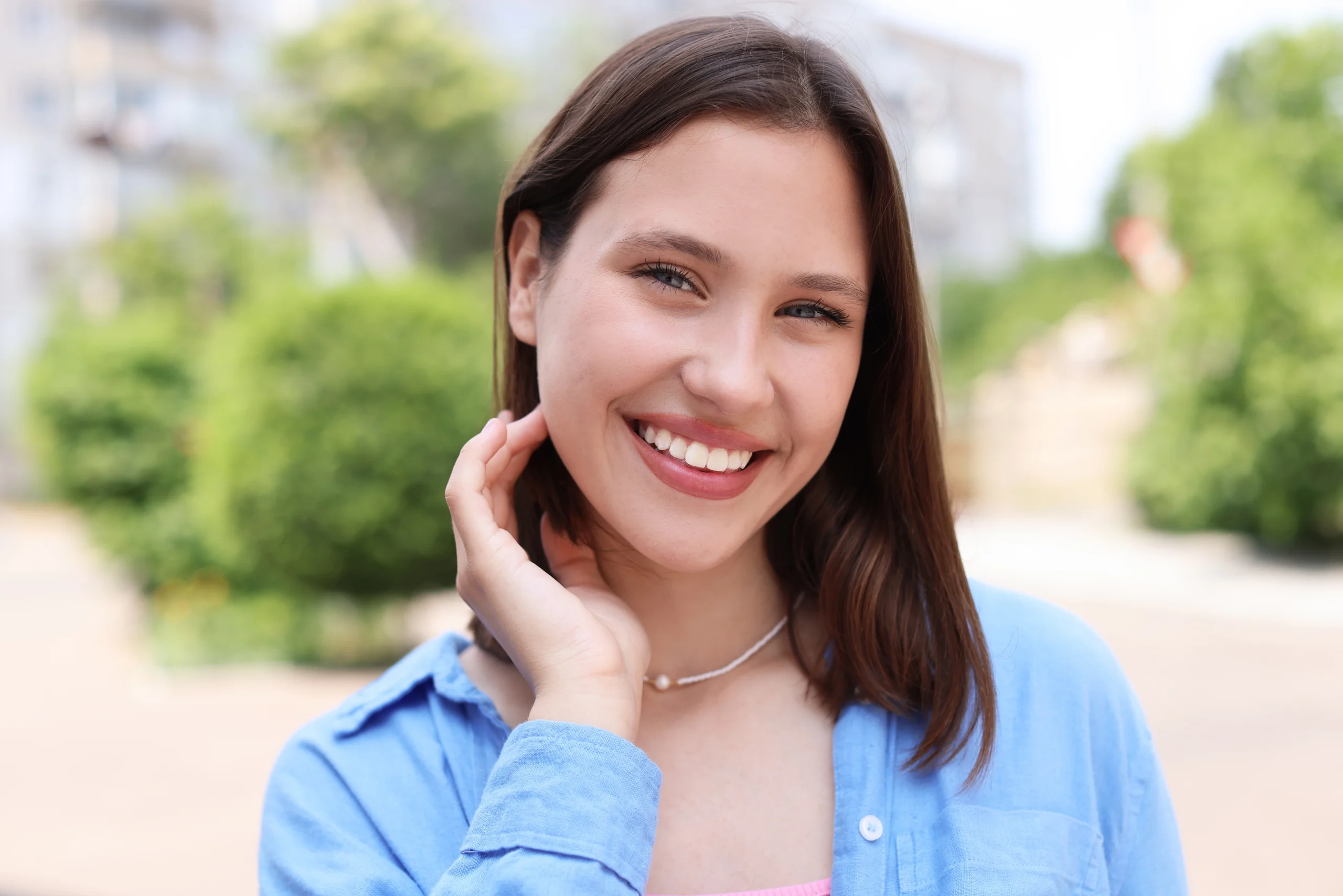 Young woman outdoors in a blue shirt
