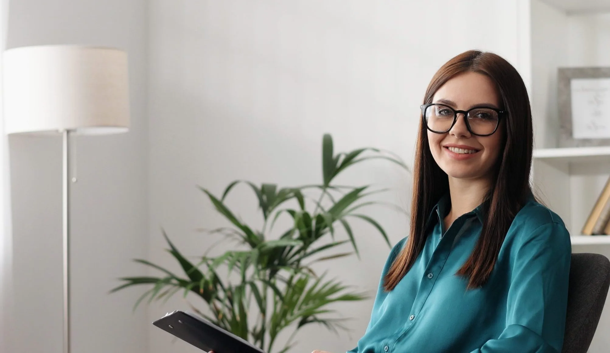 Smiling woman with glasses in an office