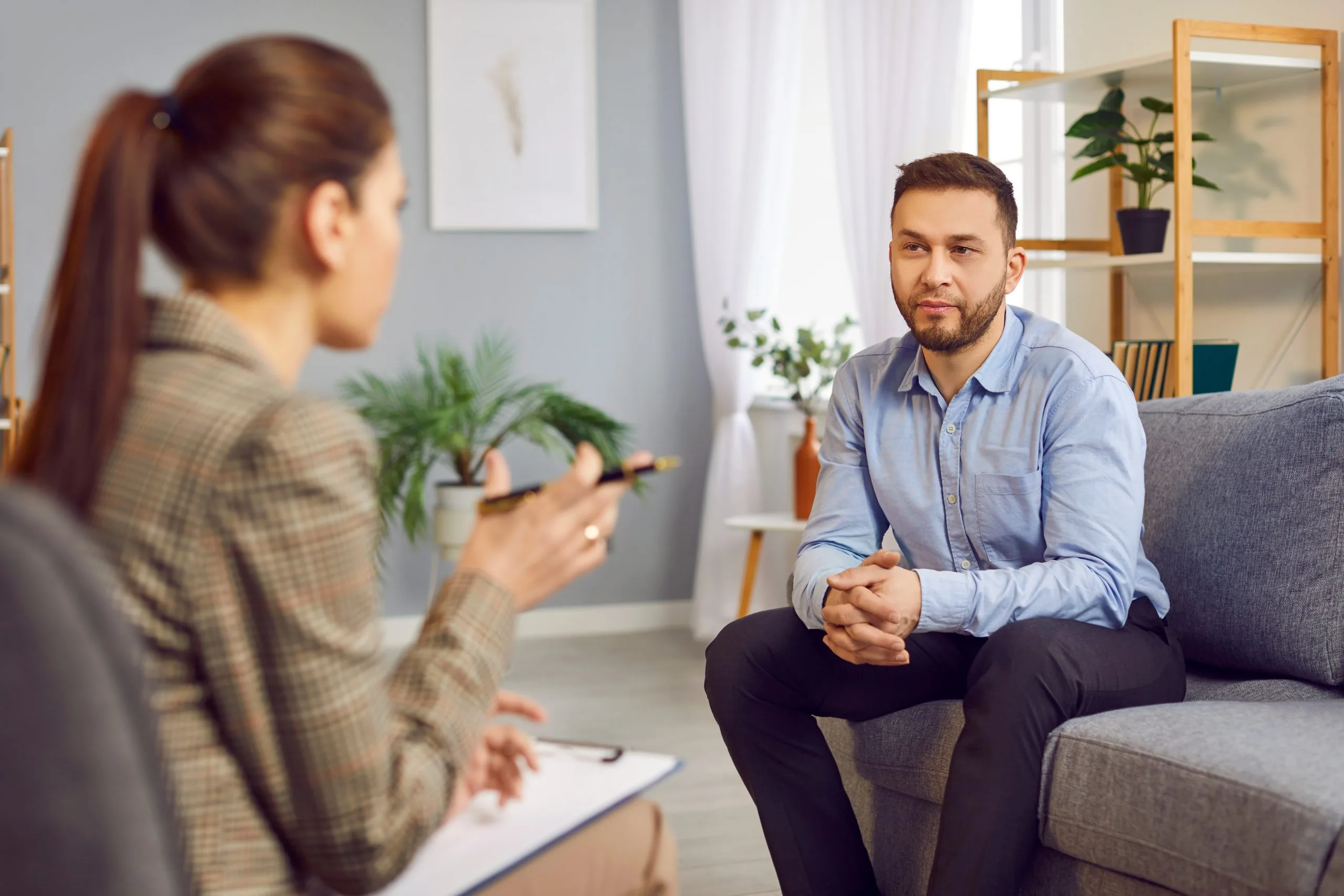 Man on a couch talking with a therapist