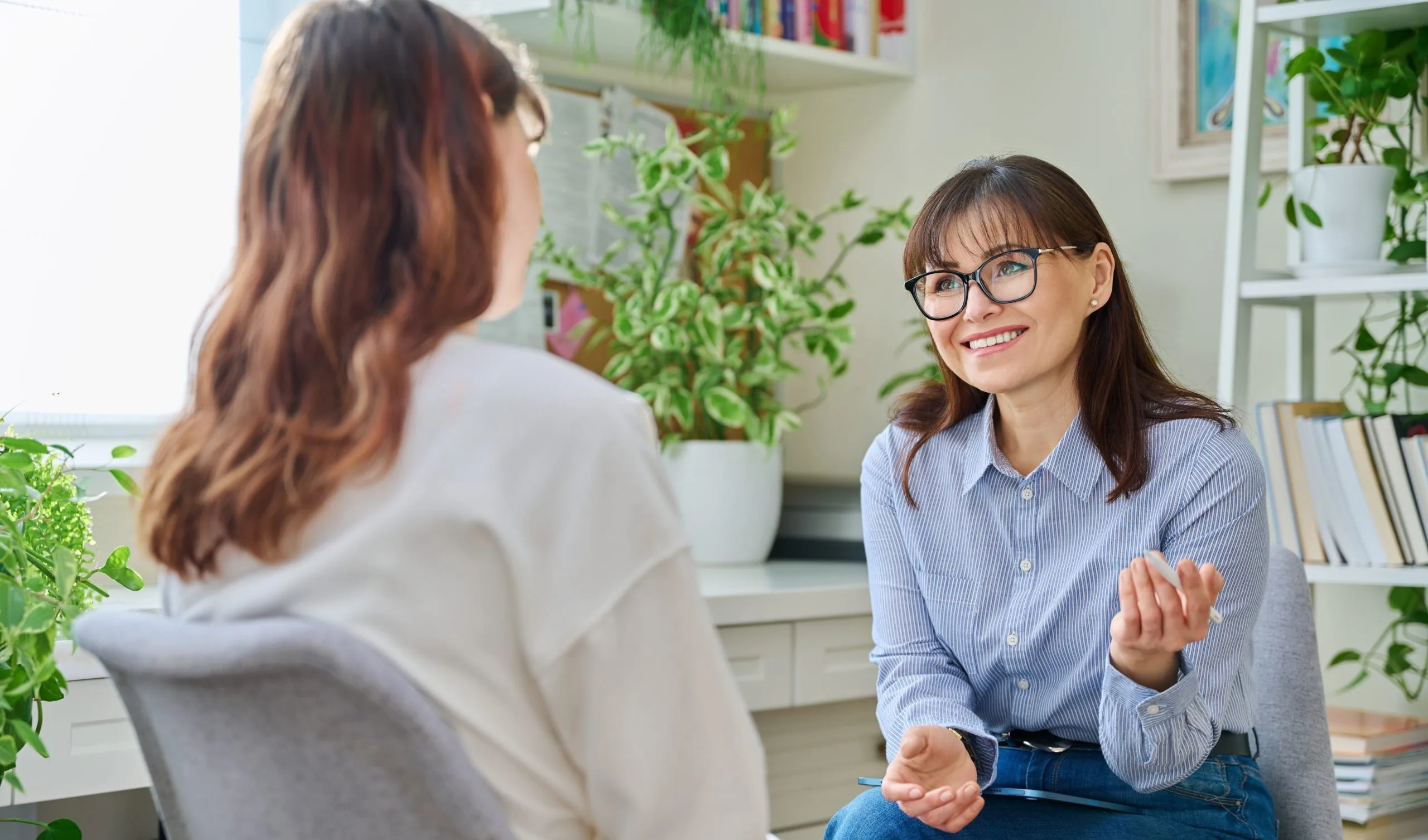 Smiling woman talking with a counselor