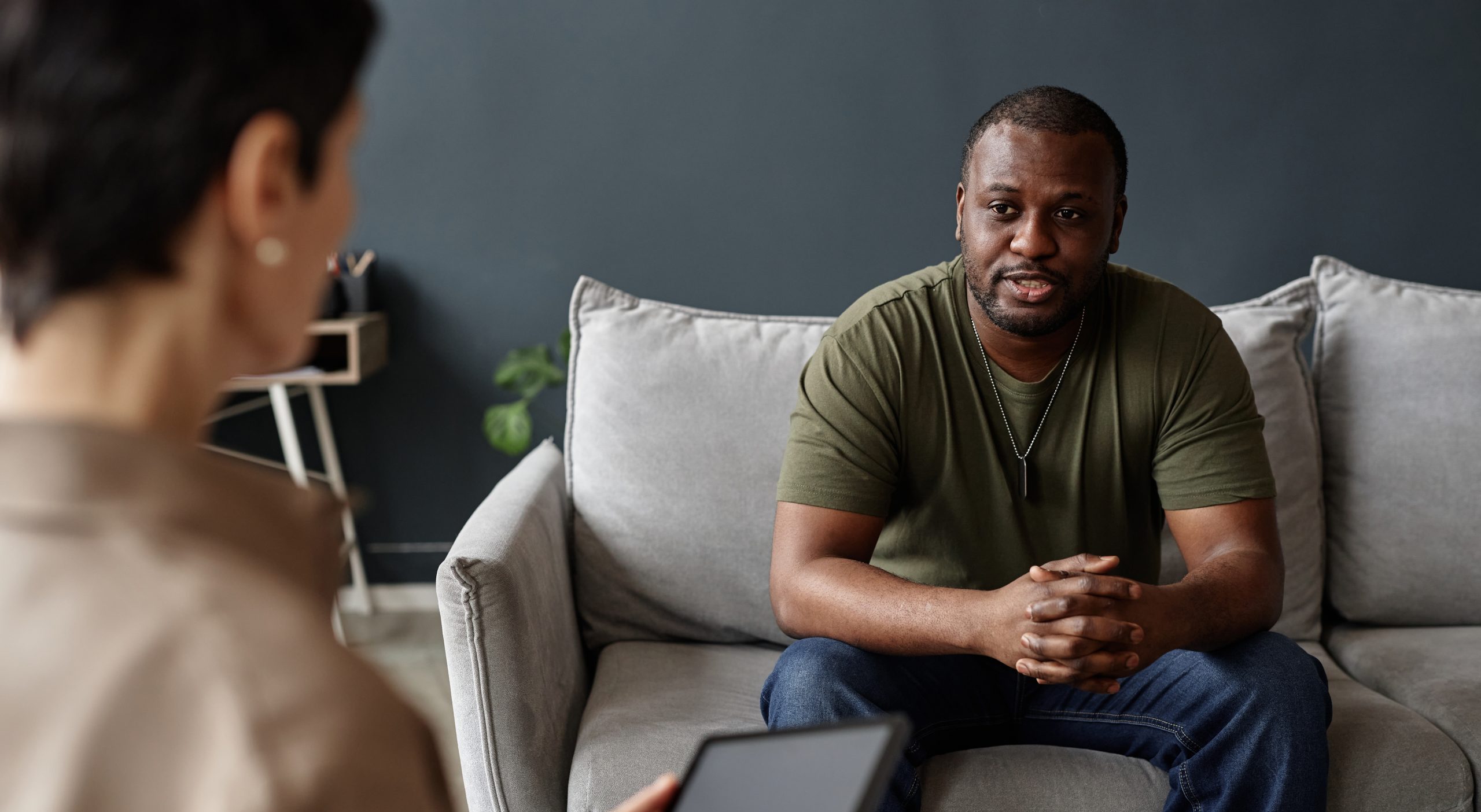 Man talking with a therapist on a sofa