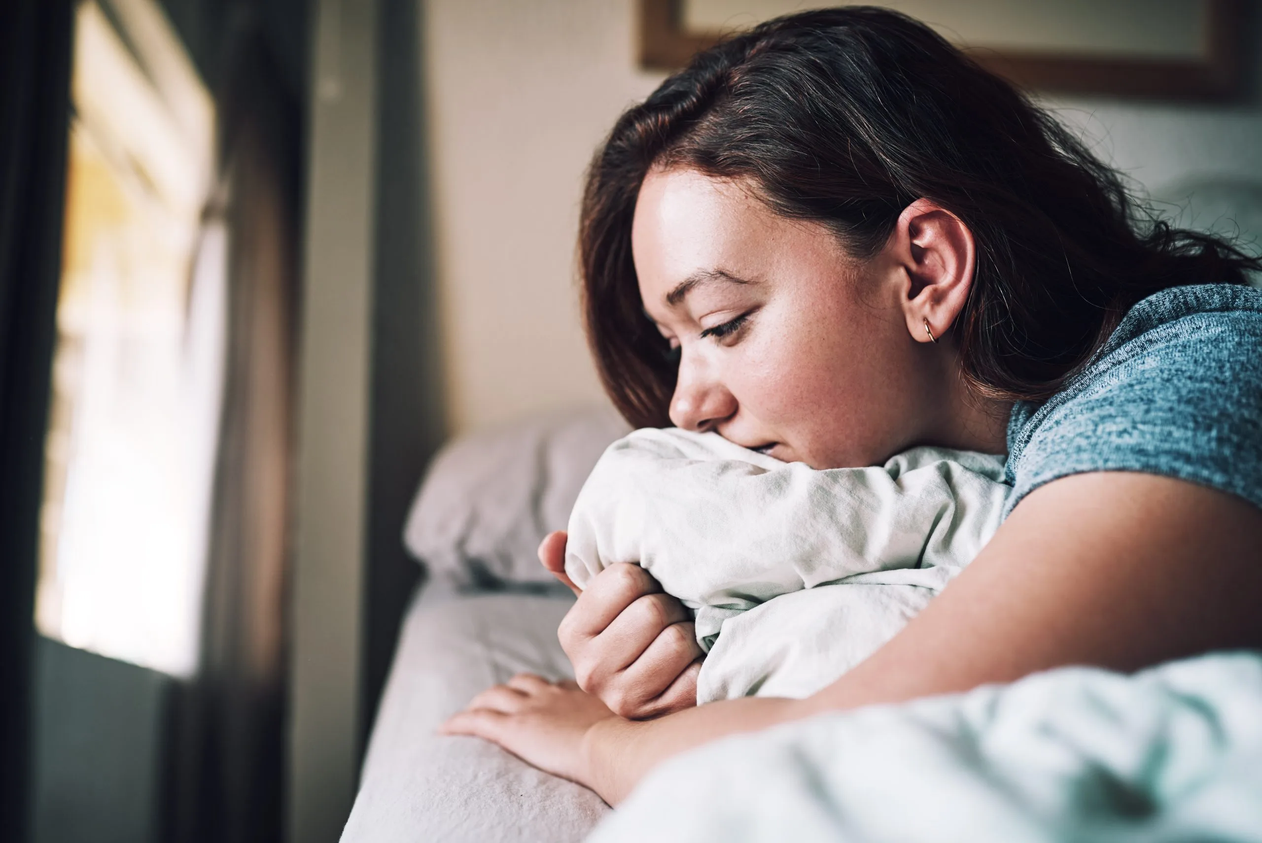 Woman resting her head on a pillow