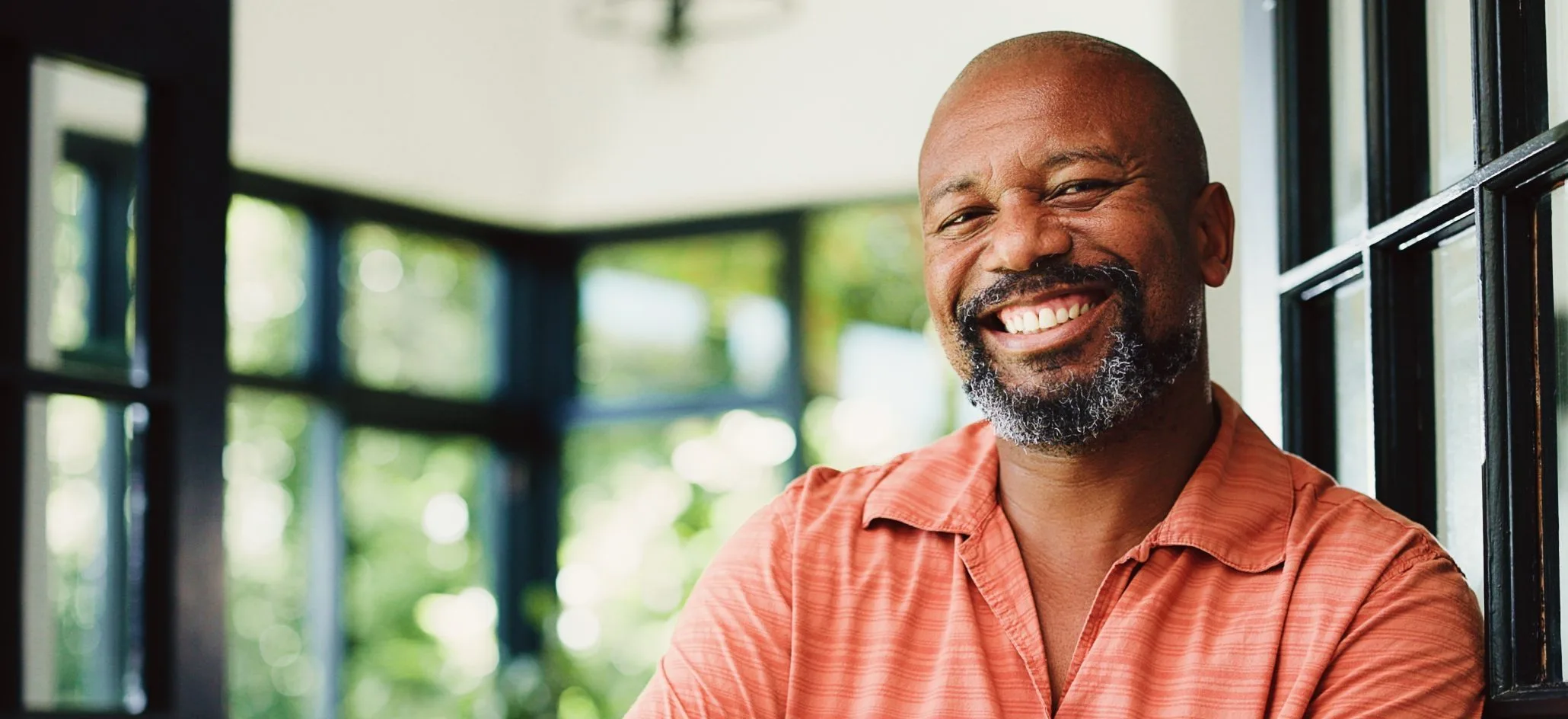 Smiling man by a window