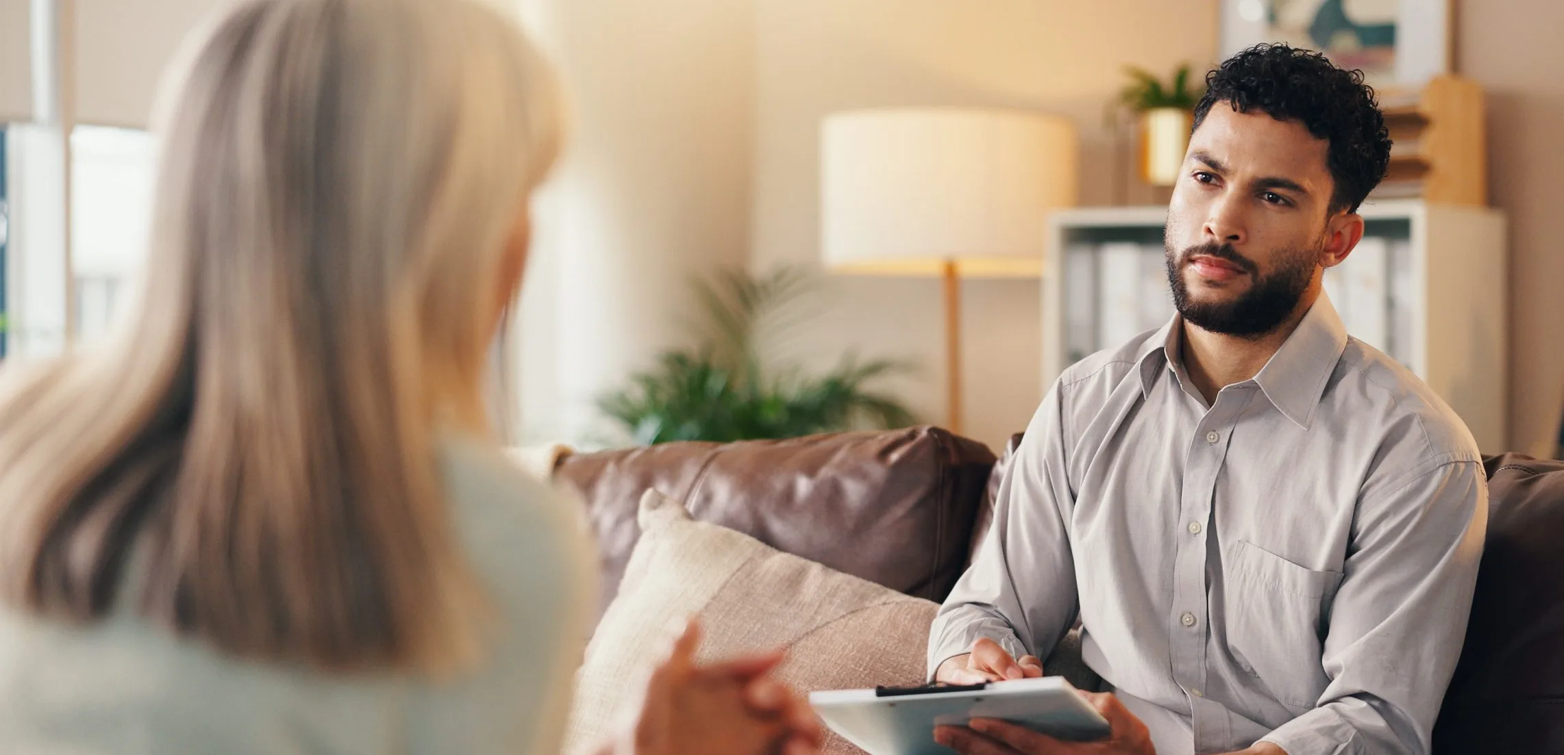 Man talking with a therapist who takes notes