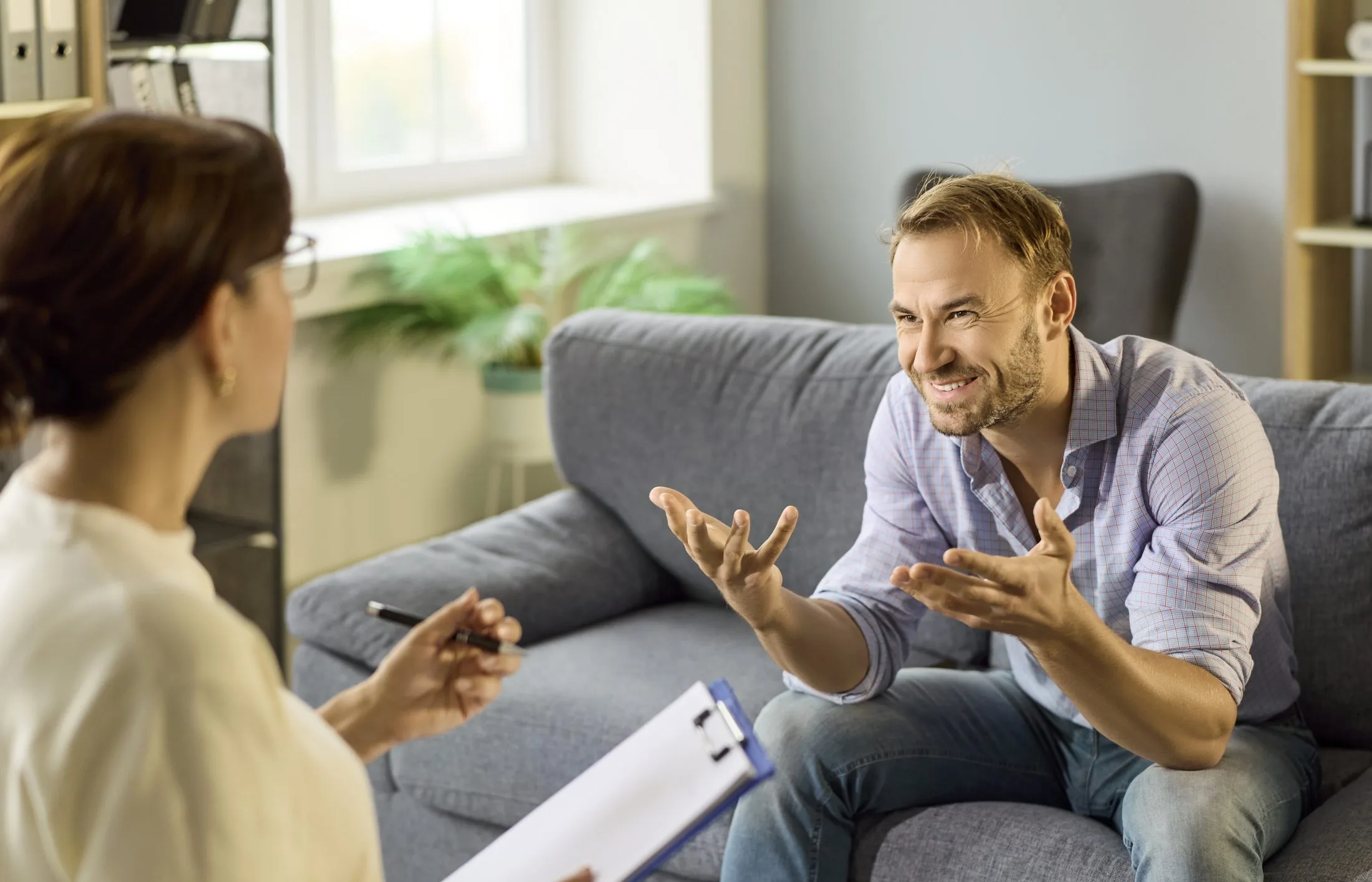 Man talking with a therapist on a couch