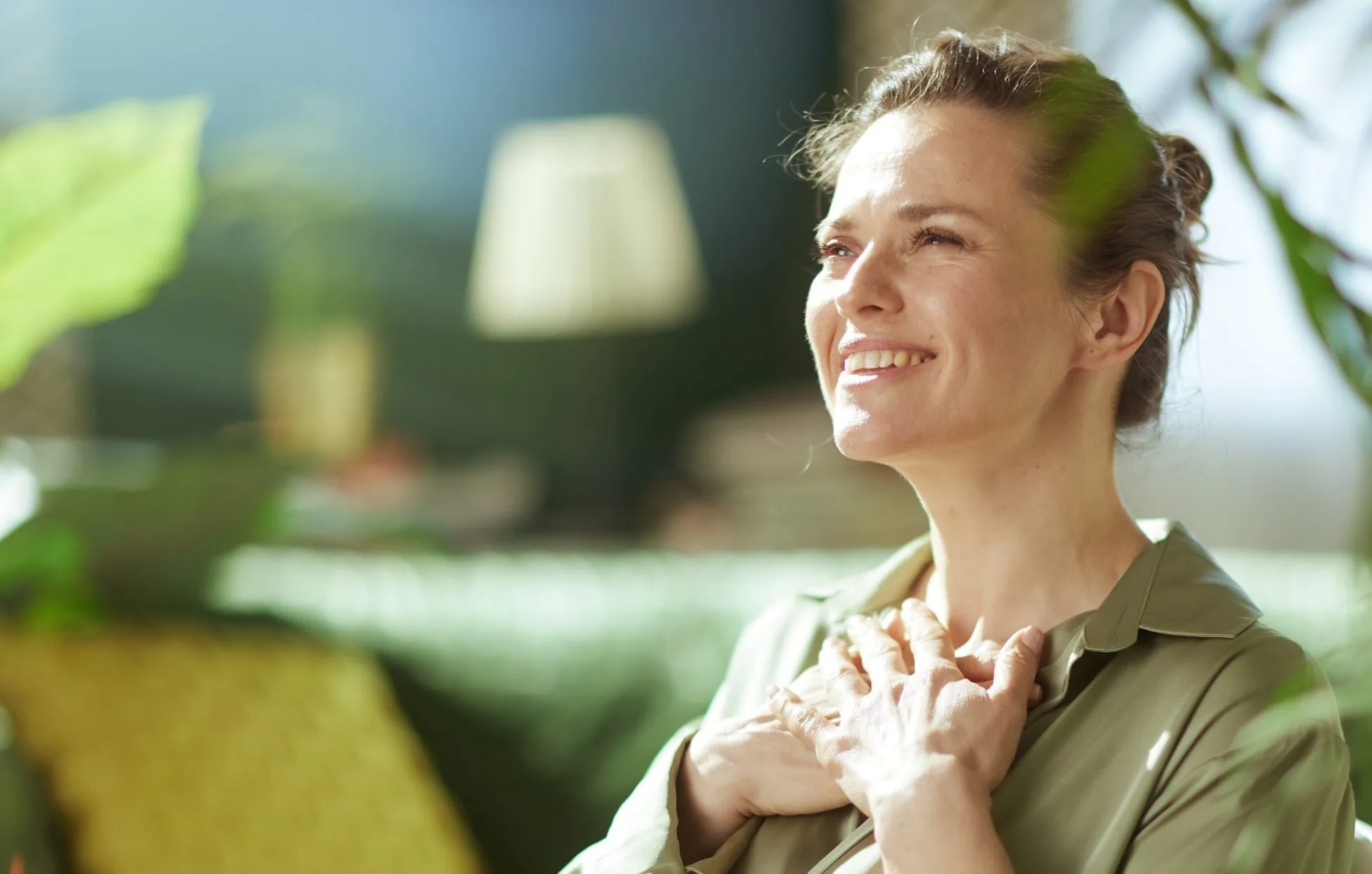 Relaxed woman smiling with her hand on her chest