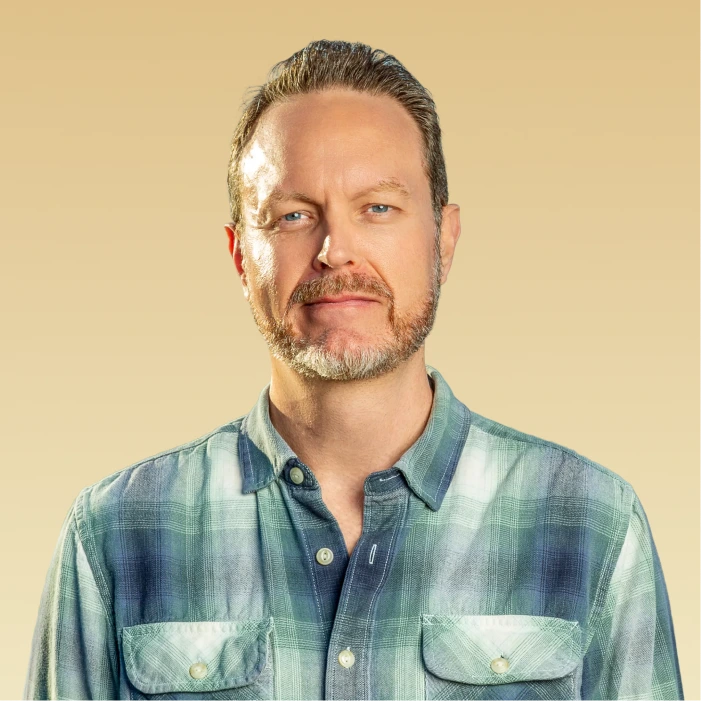 Blake Kuehn, Therapist, headshot against a tan background