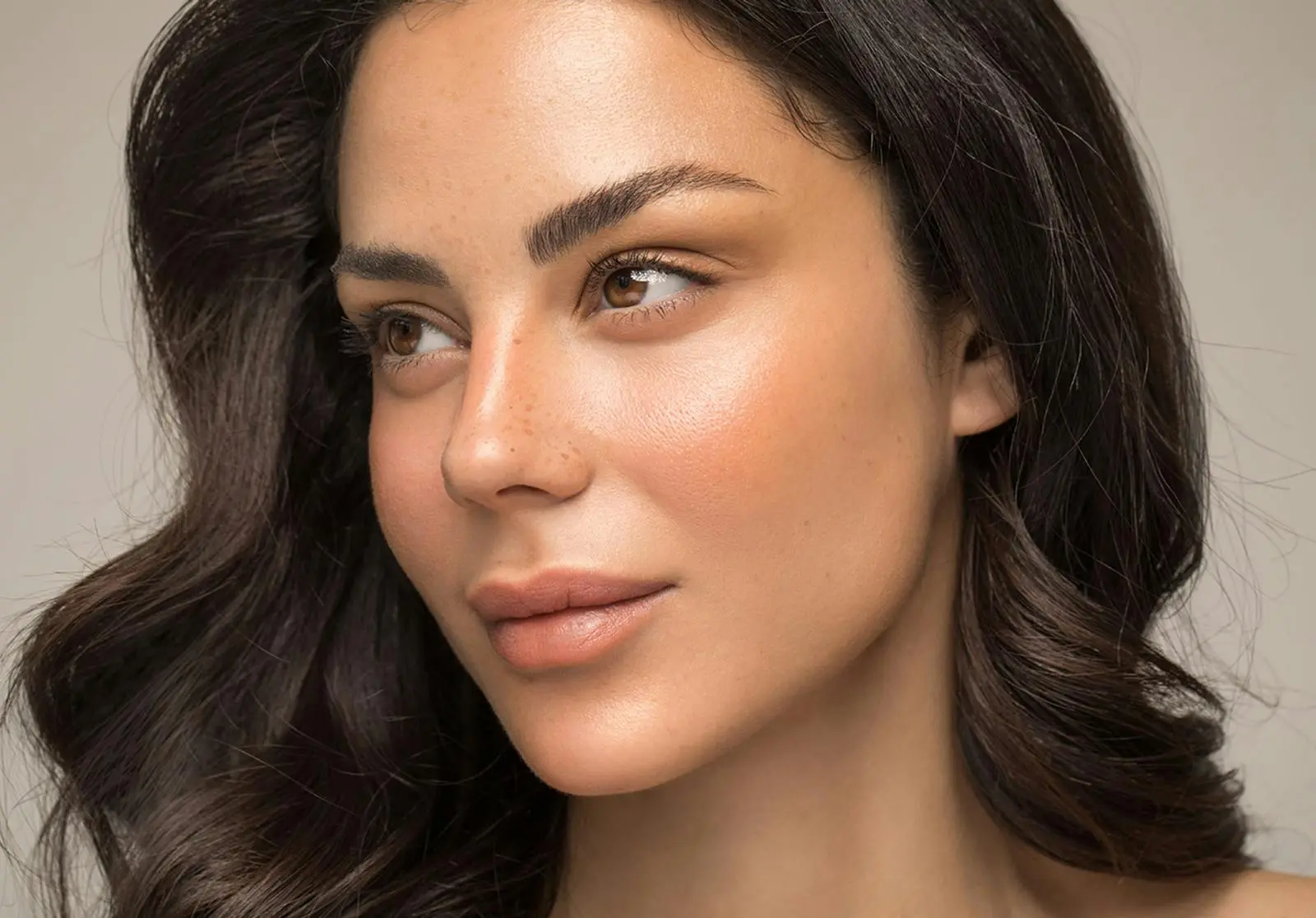 Woman with clear, glowing skin and defined facial features in profile