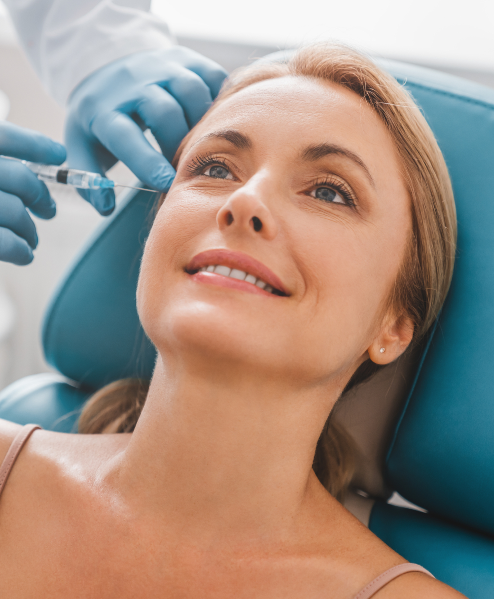 Clinician administering Botox injection to patient's forehead area