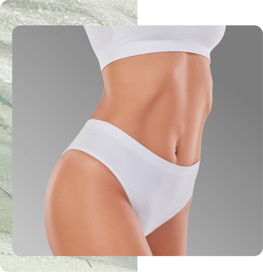 Person's torso showing toned abdominal muscles and flat stomach in white crop top and briefs