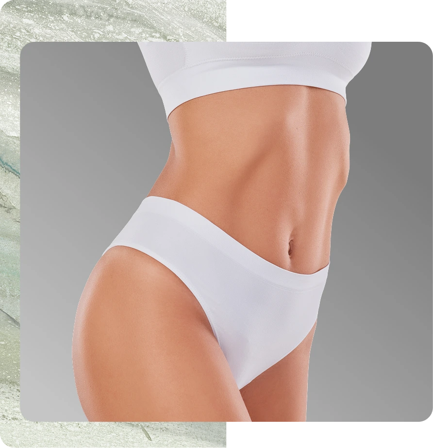 Person's torso showing toned abdominal muscles and flat stomach in white crop top and briefs
