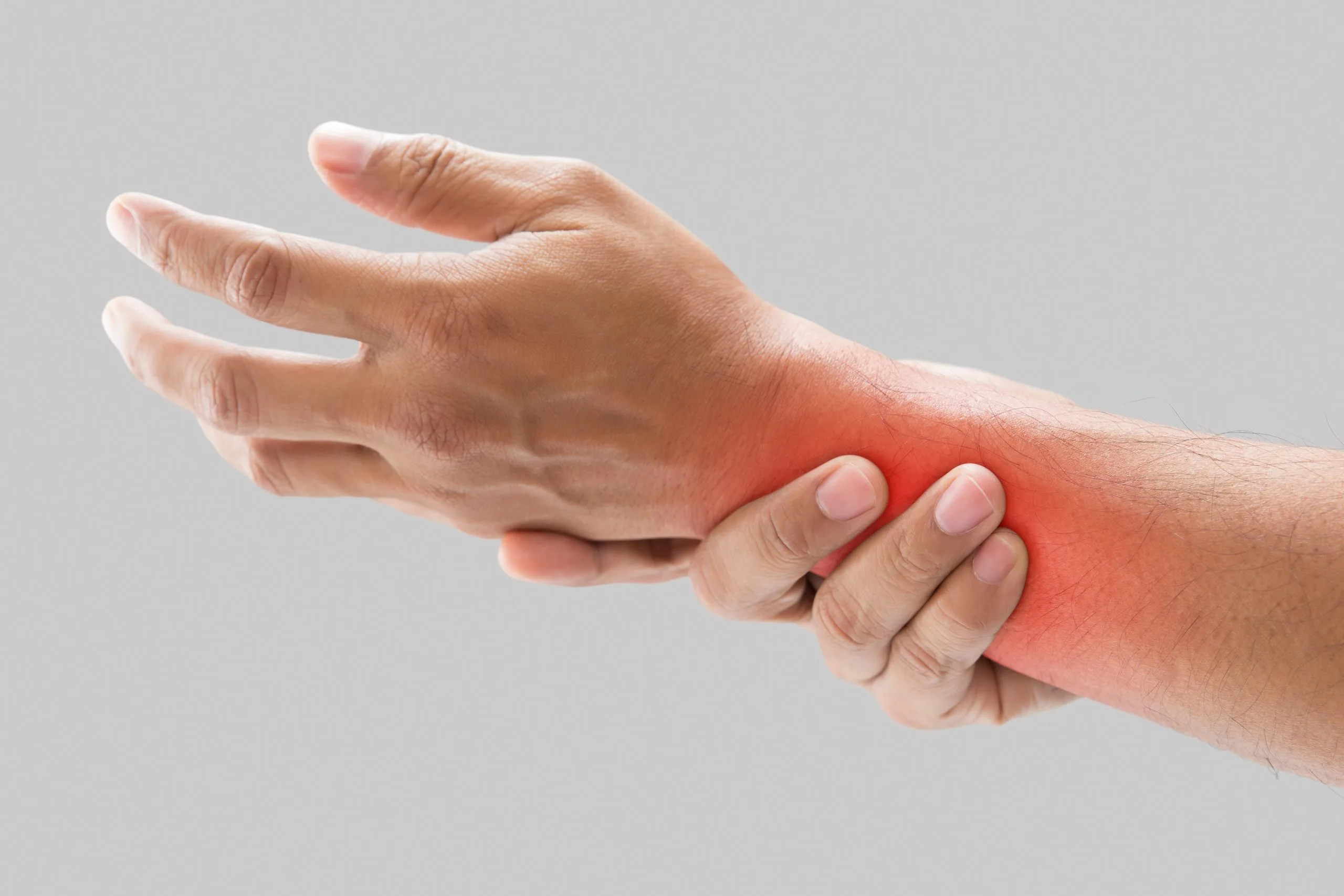 Person's hand and wrist with red highlighting area of wrist pain