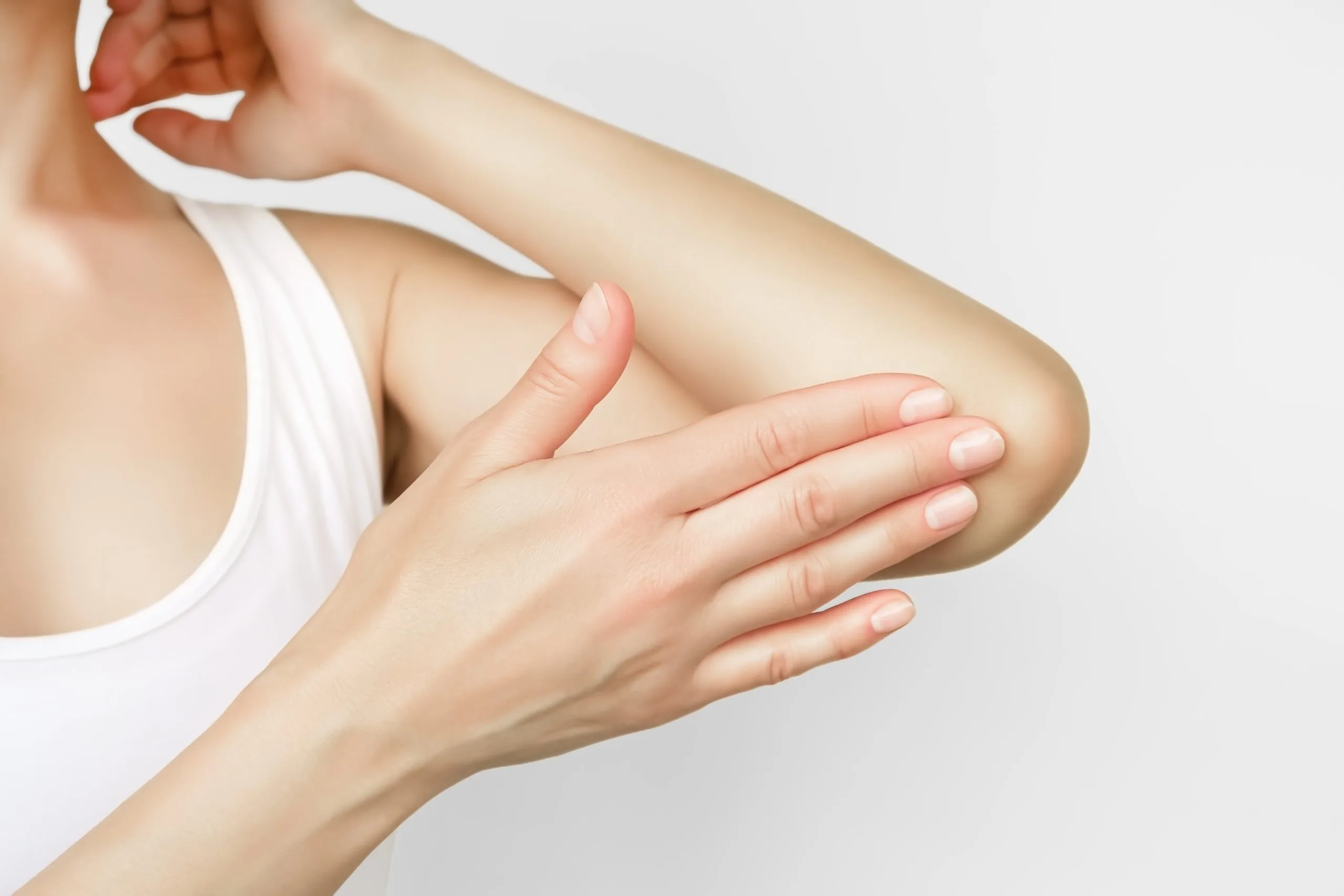 Woman examining her arm for skin condition or sensitivity