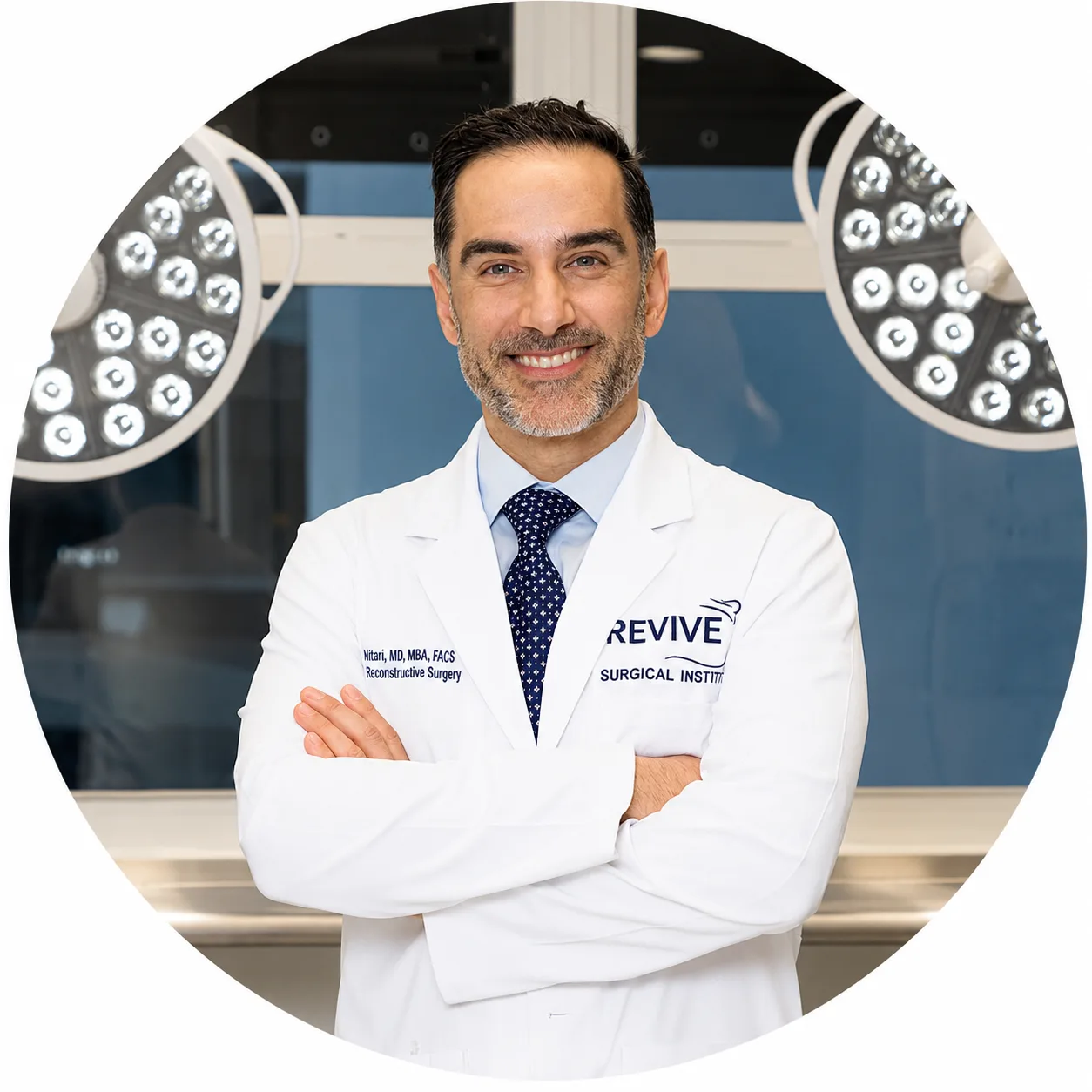 Dr. Murad in white surgical coat with arms crossed in operating room with overhead lights