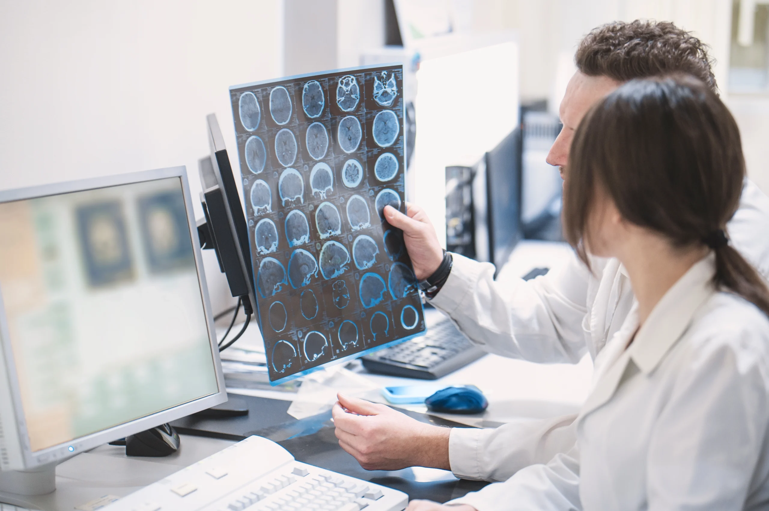 Clinicians reviewing brain scans together